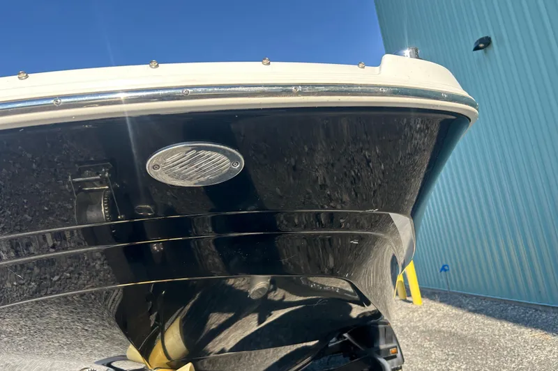 Slide: The Image of 2022 Four Winns HD2 OB boat hull close-up against blue building background. - 31