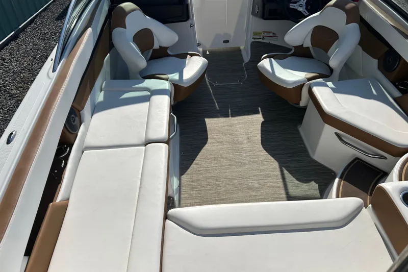 Slide: The Image of 2022 Four Winns HD2 OB boat interior with white and brown seating. - 37