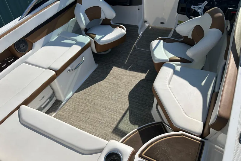 Slide: The Image of 2022 Four Winns HD2 OB boat interior with white and brown seating. - 38