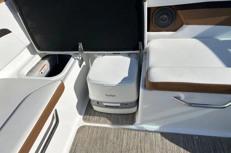 Slide: The Image of 2022 Four Winns HD2 OB boat interior with portable toilet and seating area. - 39