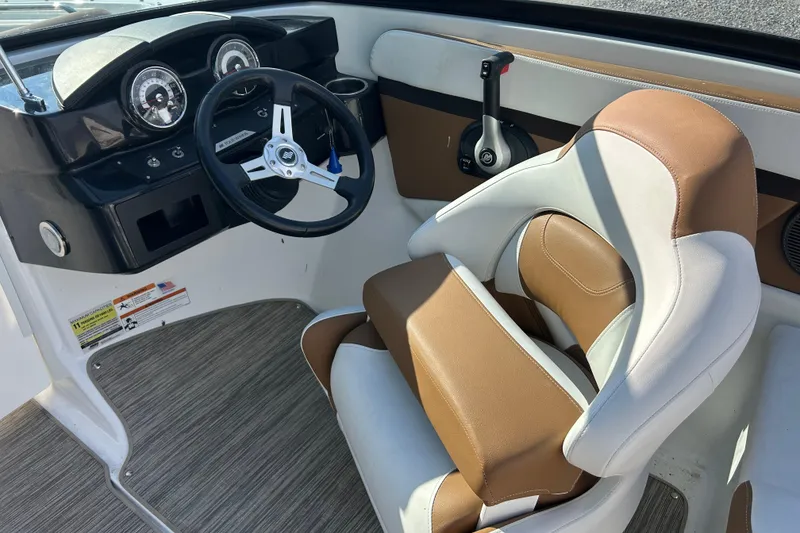 Slide: The Image of 2022 Four Winns HD2 OB boat cockpit with steering wheel and brown seating. - 41