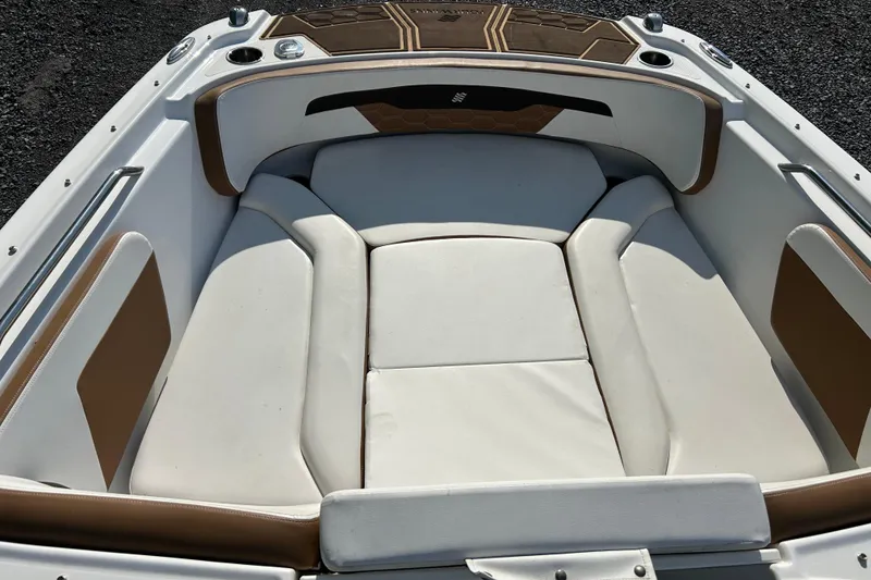 Slide: The Image of 2022 Four Winns HD2 OB boat interior with white and brown cushioned seating. - 44