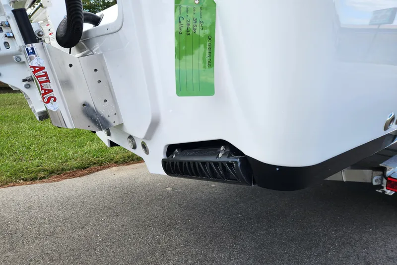 Slide: The Image of 2026 Sportsman Masters 247 Bay Boat transom with Atlas jack plate, parked on pavement. - 10