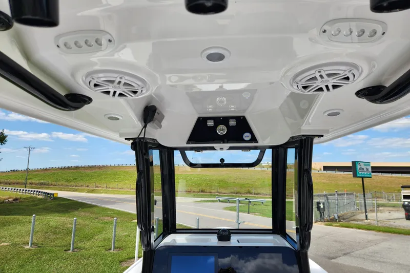 Slide: The Image of 2026 Sportsman Masters 247 Bay Boat console with speakers and controls, viewed from below. - 22