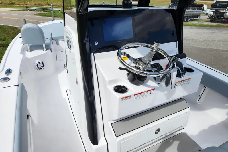 Slide: The Image of 2026 Sportsman Masters 247 Bay Boat cockpit with steering wheel and navigation display. - 23