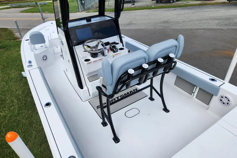 Slide: The Image of 2026 Sportsman Masters 247 Bay Boat interior with helm, seating, and rod holders. - 24