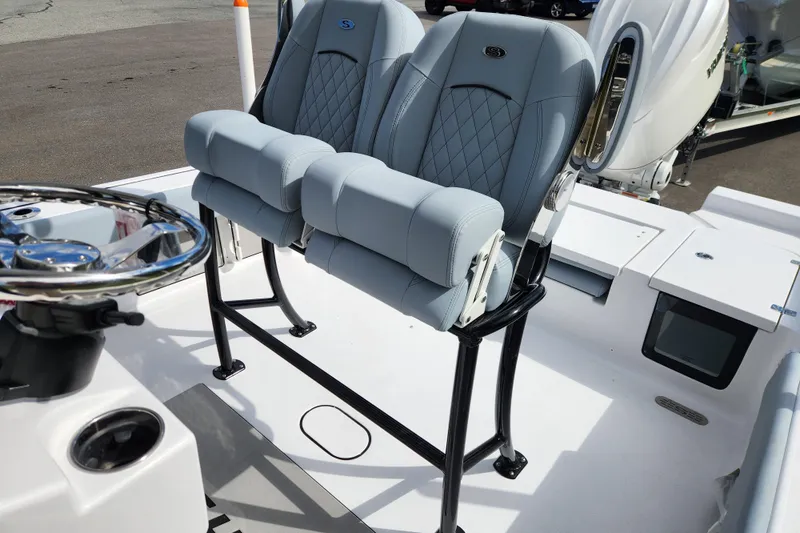 Slide: The Image of 2026 Sportsman Masters 247 Bay Boat helm with dual seats and steering wheel. - 26