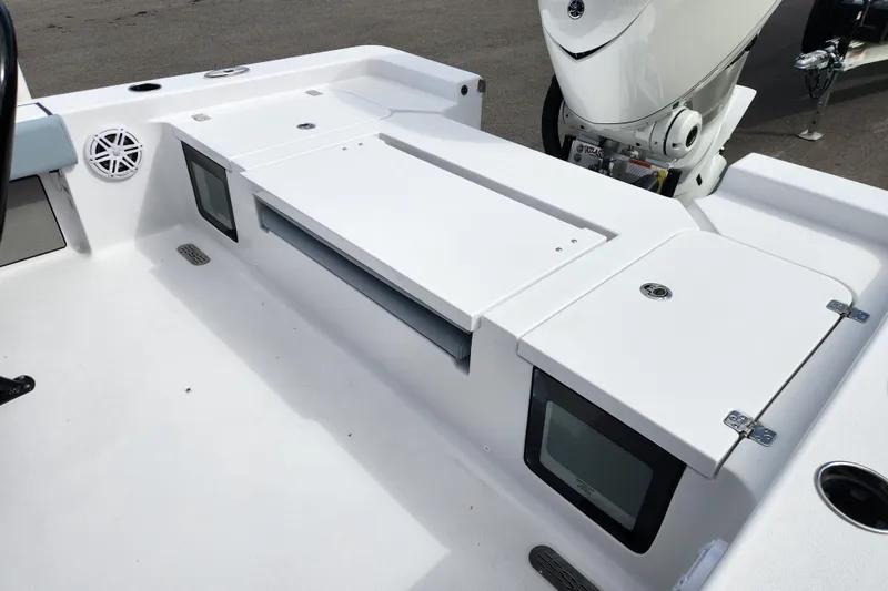 Slide: The Image of 2026 Sportsman Masters 247 Bay Boat deck with storage compartments and engine view. - 28