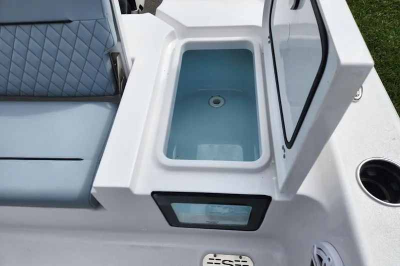 Slide: The Image of Livewell on 2026 Sportsman Masters 247 Bay Boat, open lid, blue interior. - 29