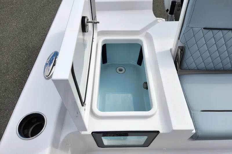 Slide: The Image of 2026 Sportsman Masters 247 Bay Boat livewell with open lid and seating area. - 30