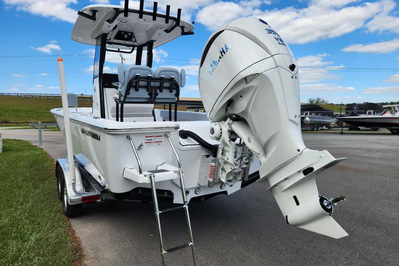 Slide: The Image of 2026 Sportsman Masters 247 Bay Boat with Yamaha outboard engine, parked outdoors. - 4