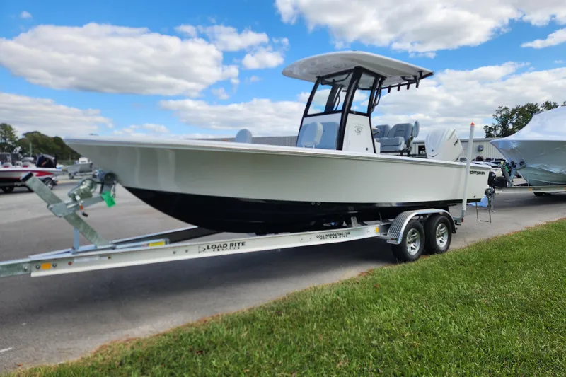 Slide: The Image of 2026 Sportsman Masters 247 Bay Boat on trailer under blue sky. - 7