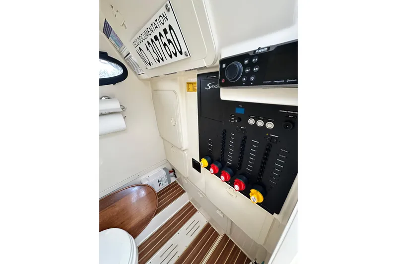 Slide: The Image of Interior view of 2020 Scout 277 LXF boat with control panel and wooden flooring. - 12