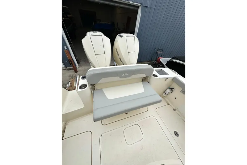 Slide: The Image of 2020 Scout 277 LXF boat with dual outboard engines and seating area. - 6
