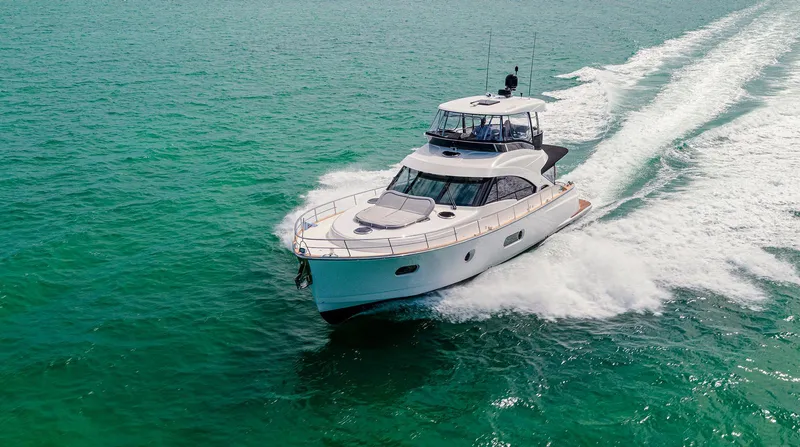 Slide: The Image of 2024 Belize 54 Daybridge yacht cruising on clear turquoise waters. - 1