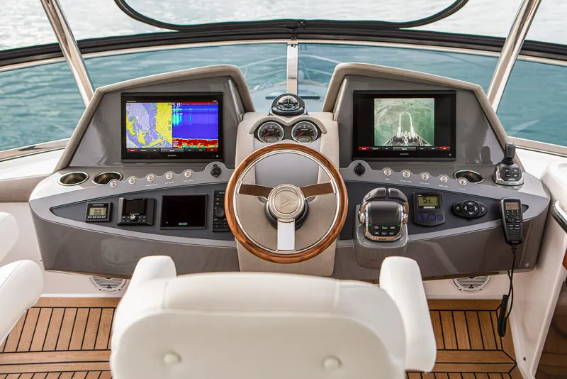 Slide: The Image of 2024 Belize 54 Daybridge yacht helm with advanced navigation systems and wooden steering wheel. - 10