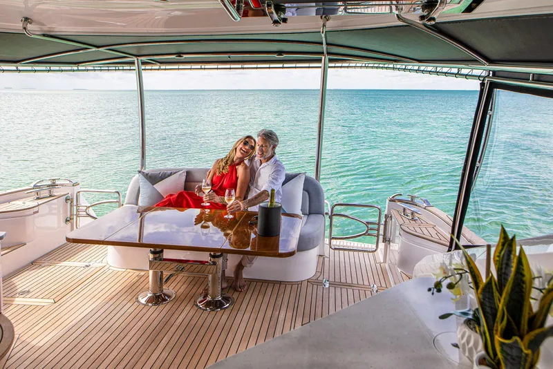 Slide: The Image of Couple relaxing on 2024 Belize 54 Daybridge yacht with ocean view. - 12