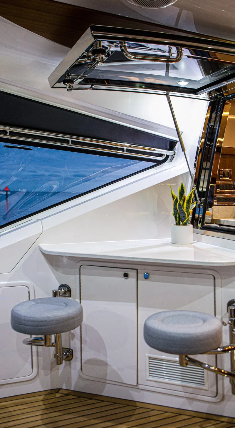 Slide: The Image of 2024 Belize 54 Daybridge yacht interior with modern seating and window view. - 13