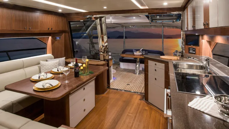 Slide: The Image of Luxurious interior of 2024 Belize 54 Daybridge yacht with dining area and sunset view. - 14