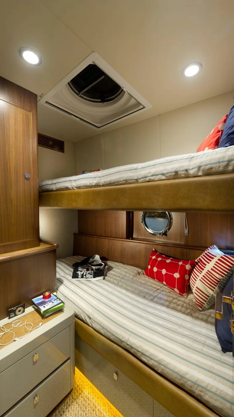 Slide: The Image of 2024 Belize 54 Daybridge yacht cabin with bunk beds and cozy decor. - 19