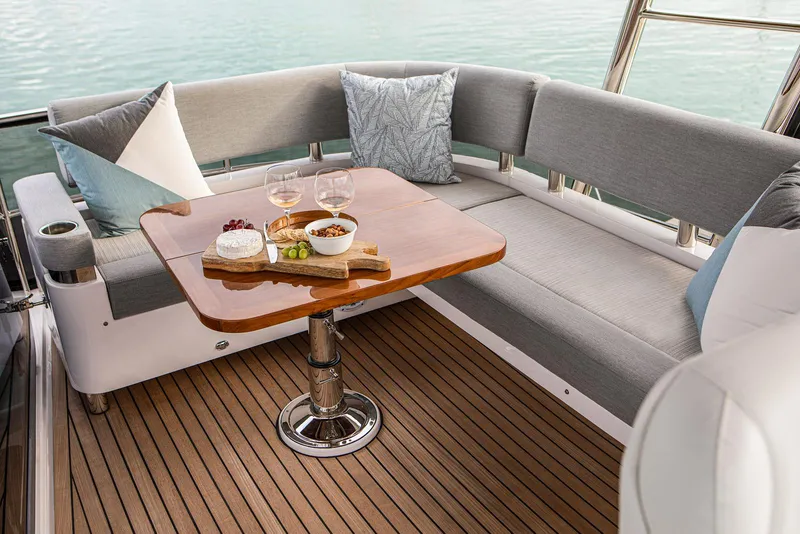 Slide: The Image of Luxurious seating area on the 2024 Belize 54 Daybridge yacht with snacks and drinks. - 8