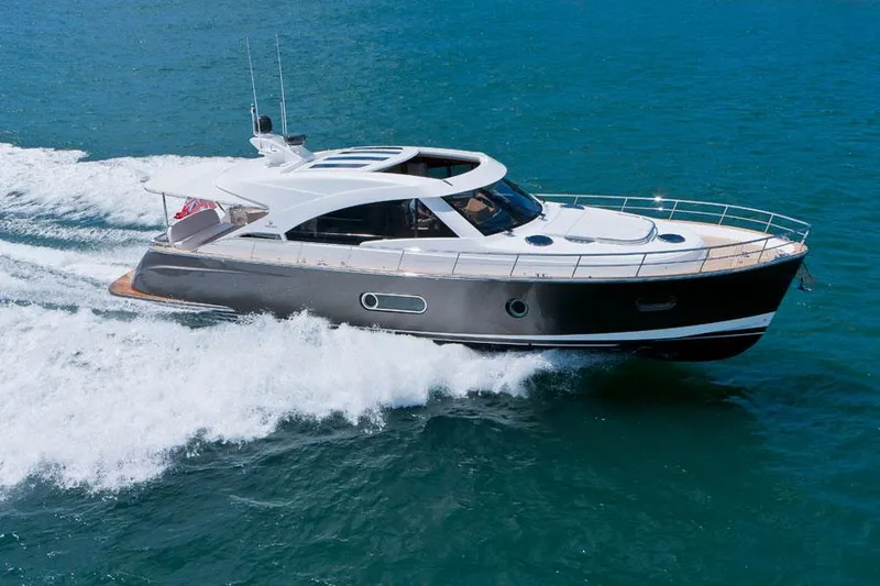 The Image of 2024 Belize 54 Sedan luxury yacht cruising on open water. - 0
