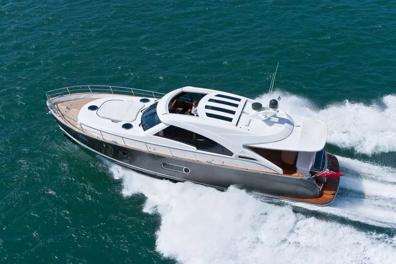 Slide: The Image of 2024 Belize 54 Sedan yacht cruising on open water. - 1