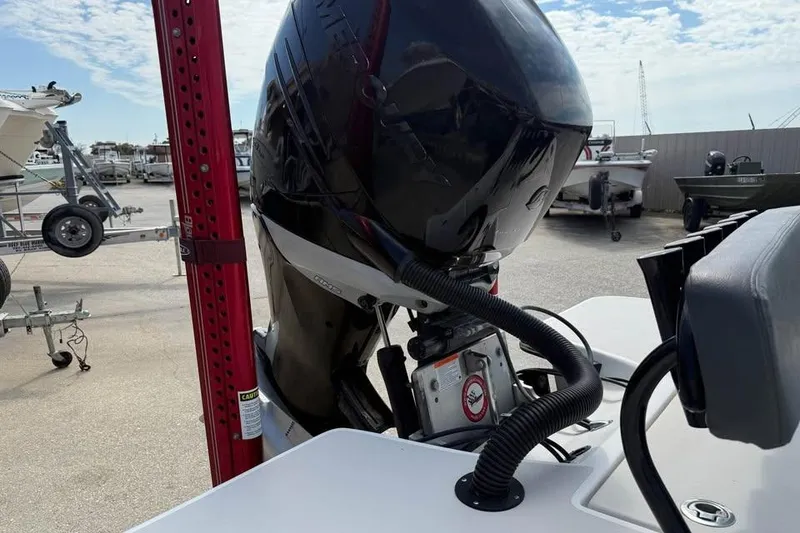 Slide: The Image of 2017 Blazer Bay 2420 GTS boat engine at a marina with trailers. - 4