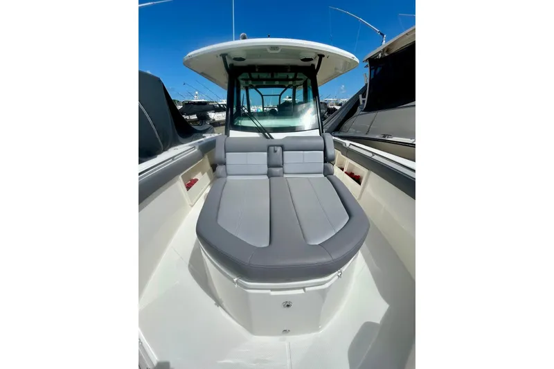 Slide: The Image of 2023 Boston Whaler 360 Outrage boat interior with cushioned seating and sleek design. - 10