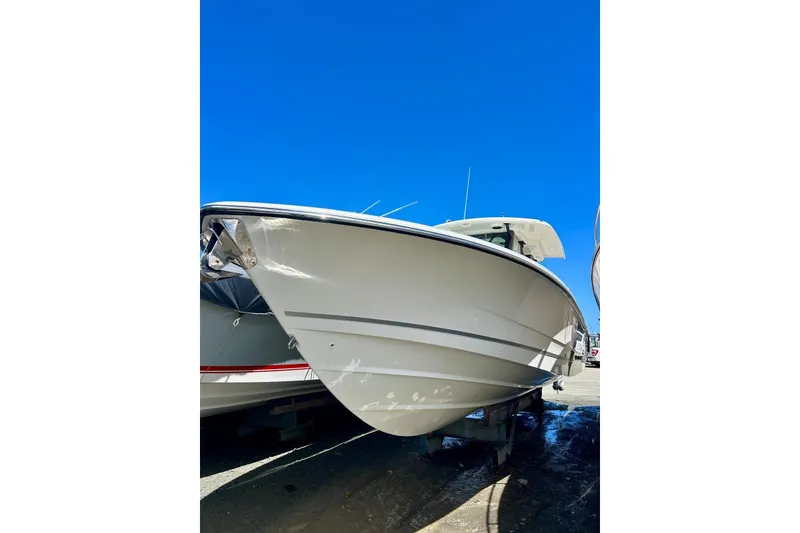 Slide: The Image of 2023 Boston Whaler 360 Outrage boat under clear blue sky. - 13