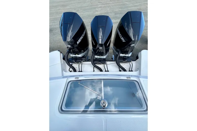 Slide: The Image of 2023 Boston Whaler 360 Outrage with triple Mercury outboard engines, rear view. - 3
