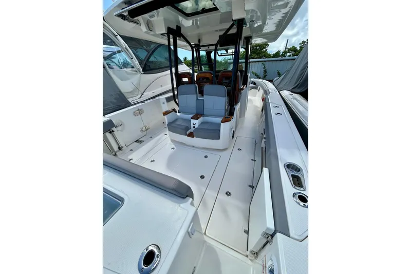 Slide: The Image of 2023 Boston Whaler 360 Outrage boat interior with seating and sleek design. - 4