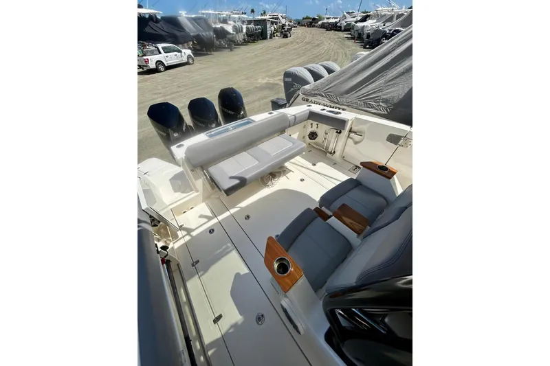 Slide: The Image of 2023 Boston Whaler 360 Outrage boat interior with seating and multiple outboard engines. - 5