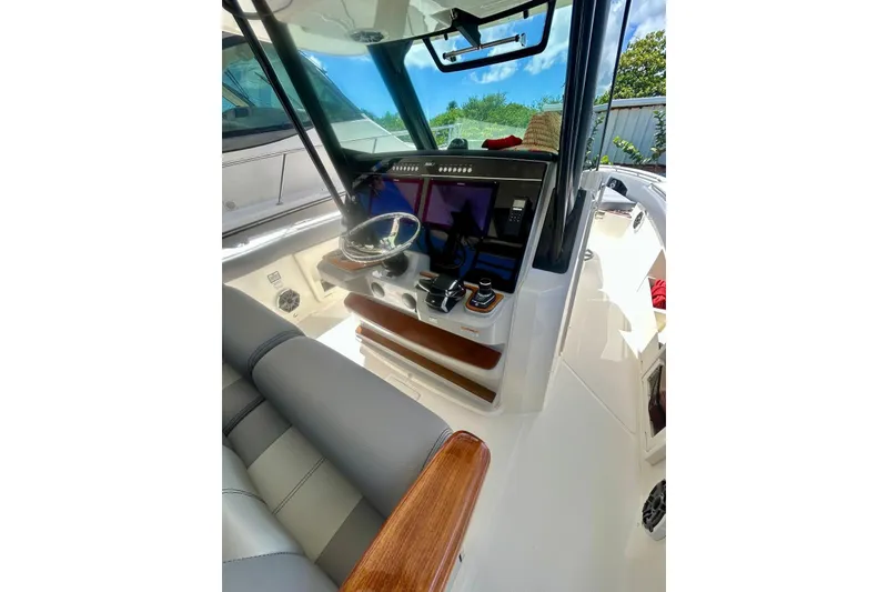 Slide: The Image of 2023 Boston Whaler 360 Outrage helm with modern controls and sleek design. - 6