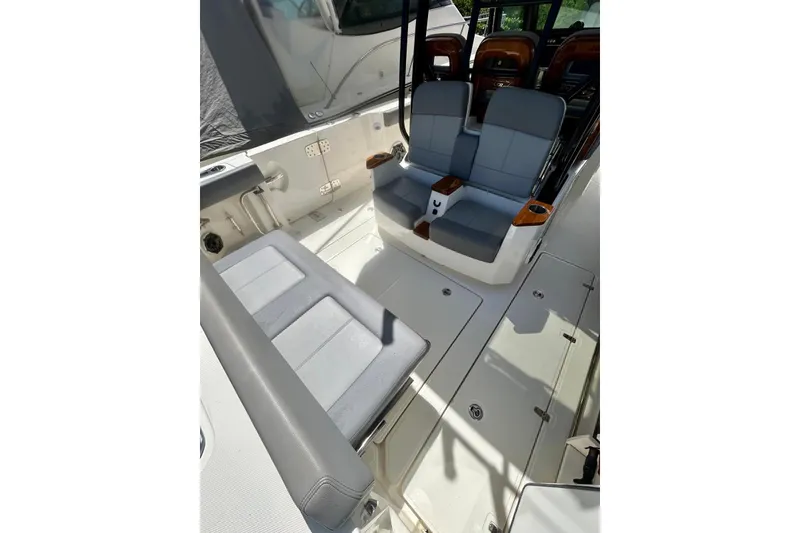 Slide: The Image of 2023 Boston Whaler 360 Outrage interior with cushioned seating and sleek design. - 7
