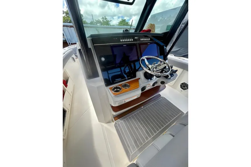 Slide: The Image of 2023 Boston Whaler 360 Outrage helm with modern controls and sleek design. - 8