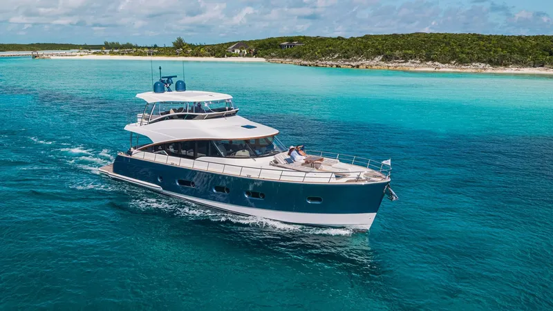 Slide: The Image of 2024 Belize 66 Daybridge yacht cruising in clear blue waters. - 1