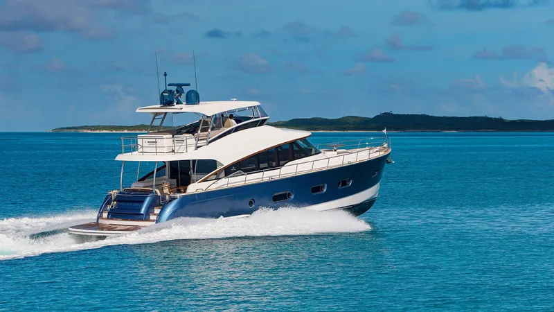 Slide: The Image of 2024 Belize 66 Daybridge yacht cruising on clear blue waters. - 10
