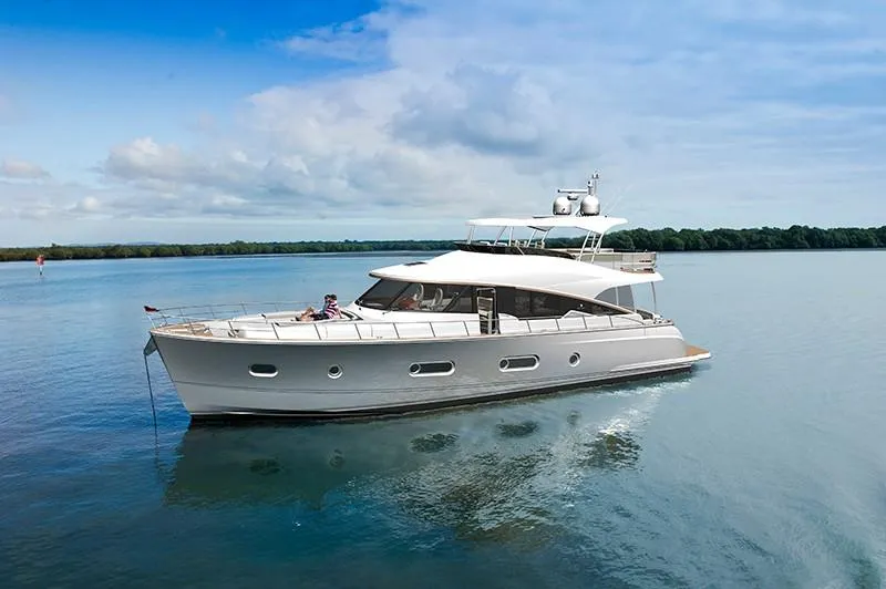 Slide: The Image of 2024 Belize 66 Daybridge luxury yacht cruising on calm waters. - 2