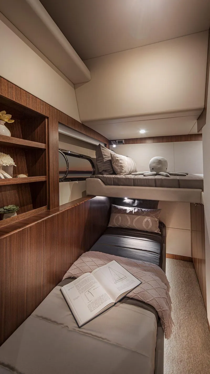 Slide: The Image of 2024 Belize 66 Daybridge yacht cabin with bunk beds and wooden shelving. - 21