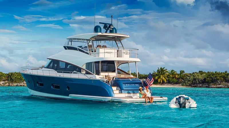 Slide: The Image of 2024 Belize 66 Daybridge yacht anchored in turquoise waters near a tropical island. - 8