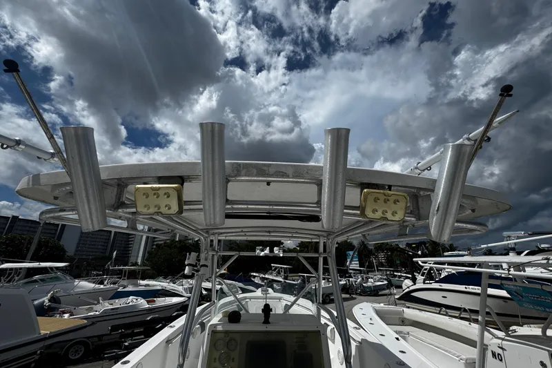 Slide: The Image of 2008 Sea Fox 287 CC boat with rod holders and electronics, under a cloudy sky. - 10