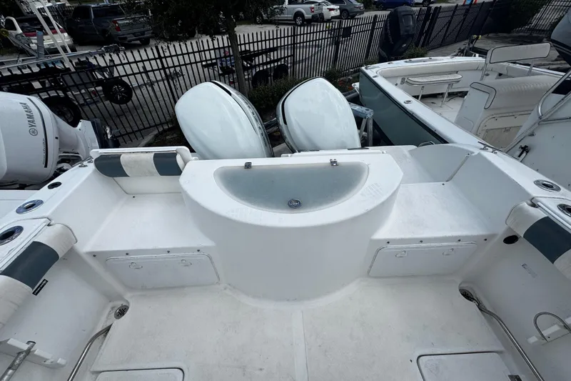 Slide: The Image of 2008 Sea Fox 287 CC boat interior with dual Yamaha engines and spacious deck layout. - 2