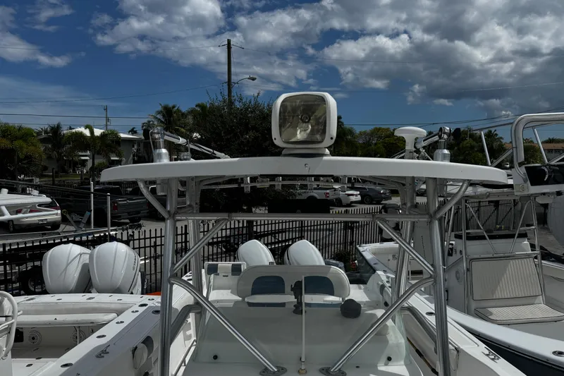 Slide: The Image of 2008 Sea Fox 287 CC boat with T-top and spotlight, parked outdoors under cloudy sky. - 23