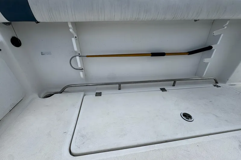 Slide: The Image of 2008 Sea Fox 287 CC boat interior with storage compartment and mounted tool. - 3