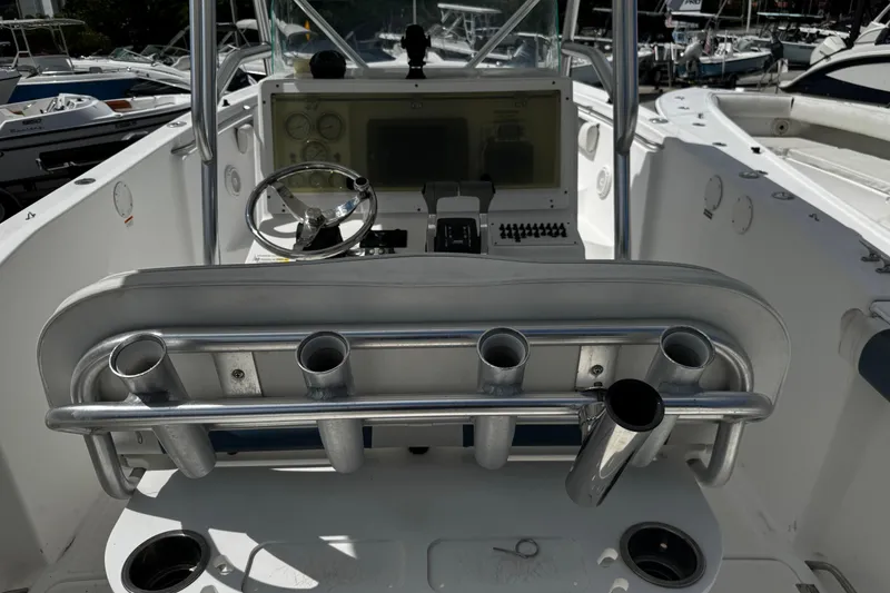 Slide: The Image of 2008 Sea Fox 287 CC boat cockpit with steering wheel and rod holders. - 30