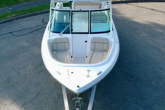 Slide: The Image of 2018 Pursuit DC 265 Dual Console boat, aerial view, parked on pavement. - 11