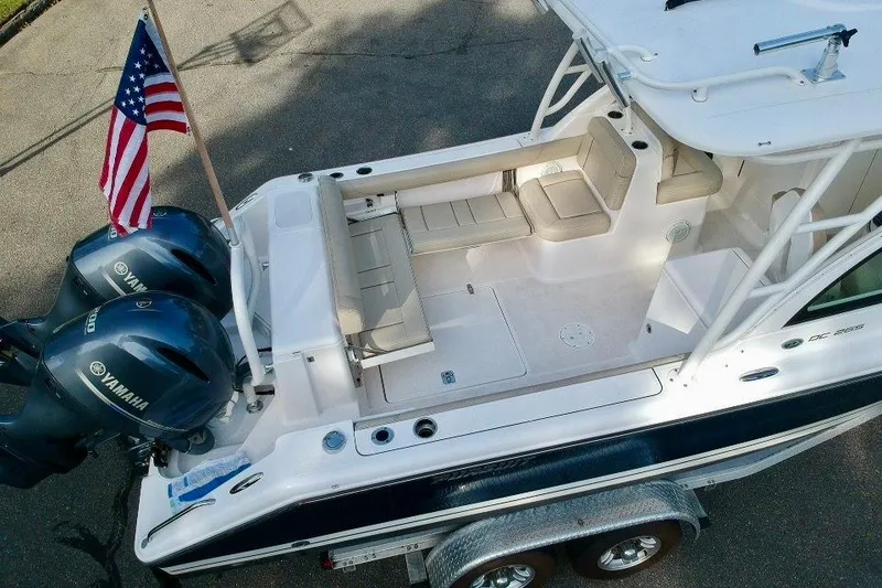 Slide: The Image of 2018 Pursuit DC 265 Dual Console boat with Yamaha engines and American flag. - 20