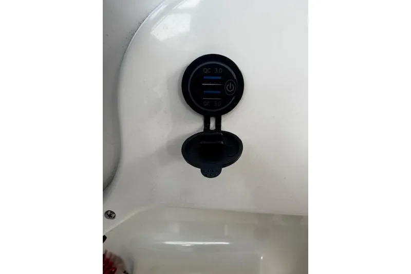 Slide: The Image of USB charging port on 2018 Pursuit DC 265 Dual Console boat dashboard. - 22