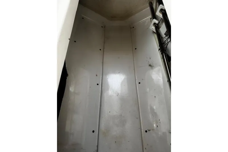 Slide: The Image of Interior view of a 2018 Pursuit DC 265 Dual Console boat compartment. - 23